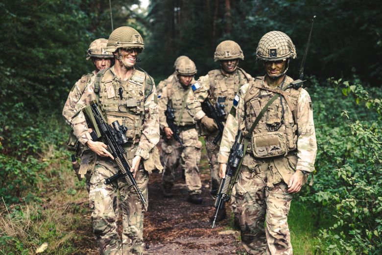 soldiers walking through forest